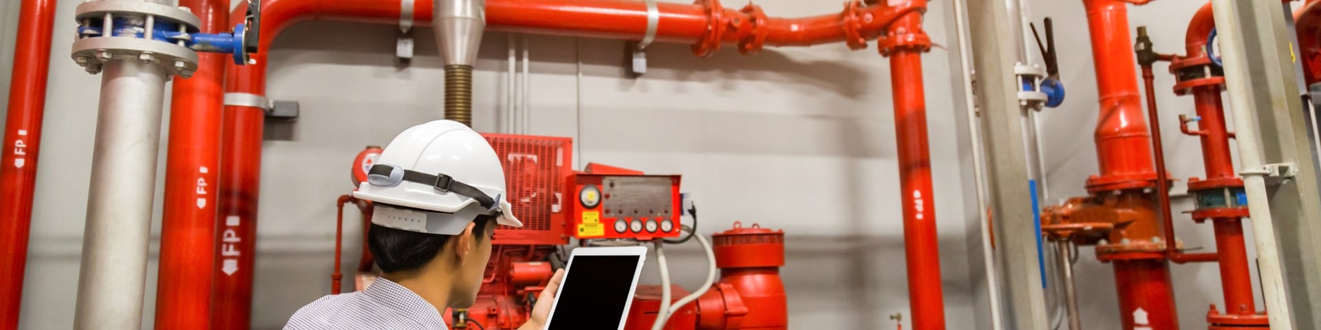 engineer checking fire alarm control system 