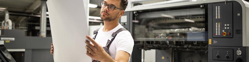 print shop working checking quality of prints